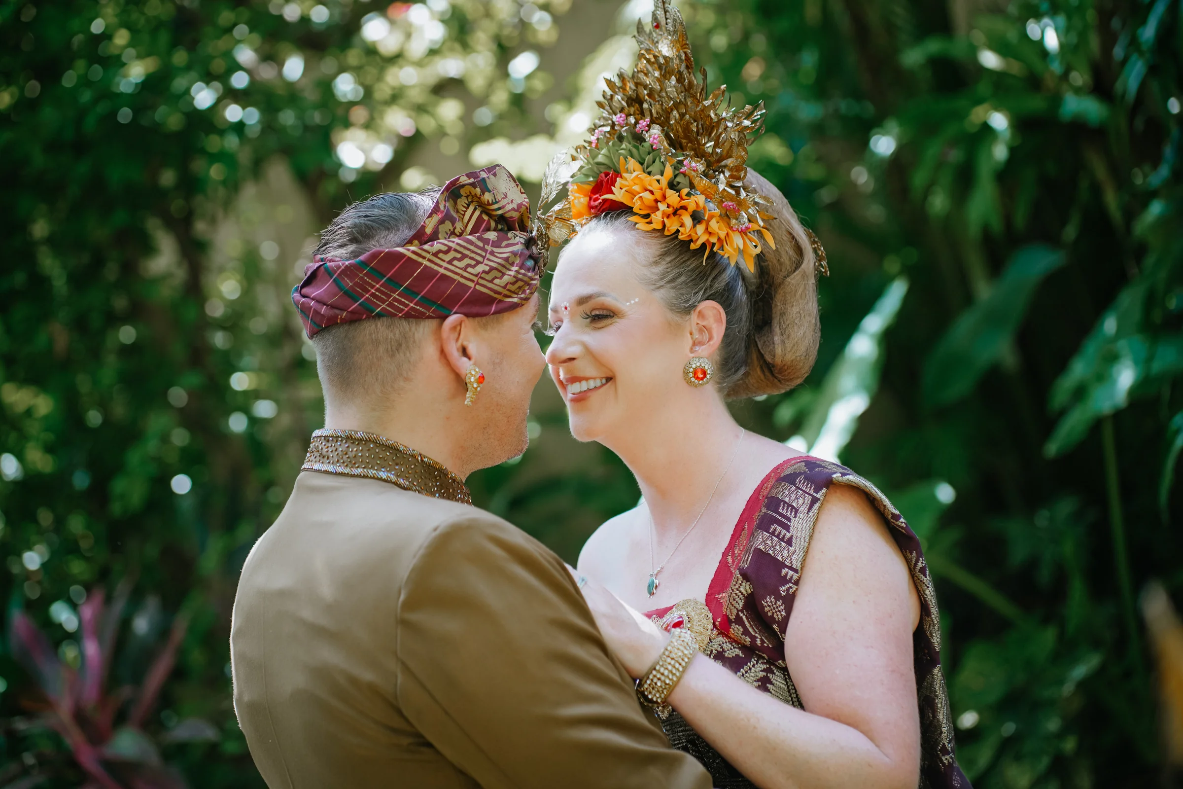 An intimate portrait of a couple in Balinese ceremonial attire at Mahagiri Villas